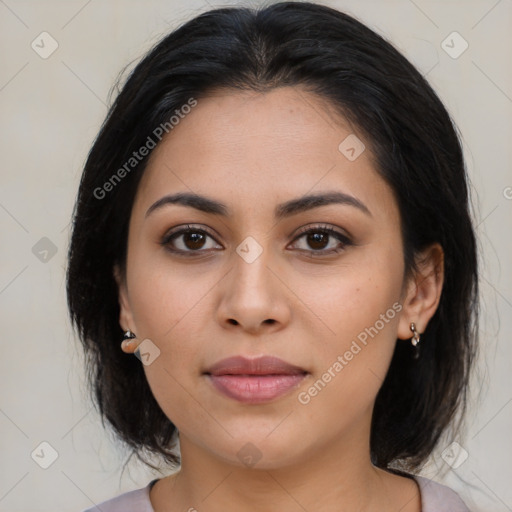 Joyful latino young-adult female with medium  brown hair and brown eyes