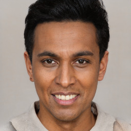 Joyful latino young-adult male with short  black hair and brown eyes