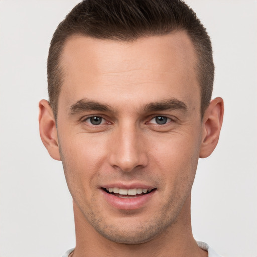 Joyful white young-adult male with short  brown hair and brown eyes