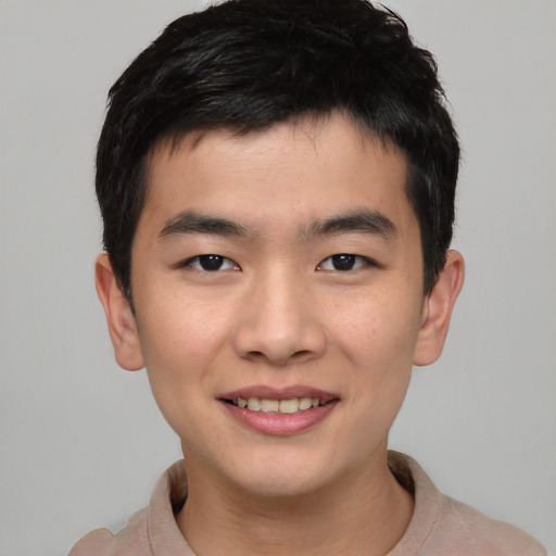 Joyful asian young-adult male with short  brown hair and brown eyes