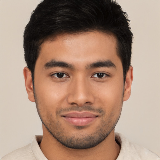 Joyful latino young-adult male with short  brown hair and brown eyes