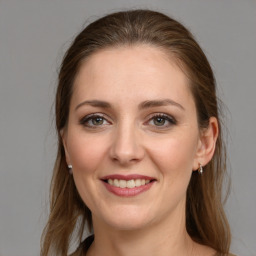 Joyful white young-adult female with long  brown hair and grey eyes