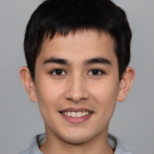 Joyful asian young-adult male with short  brown hair and brown eyes