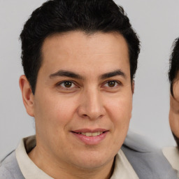 Joyful latino young-adult male with short  brown hair and brown eyes