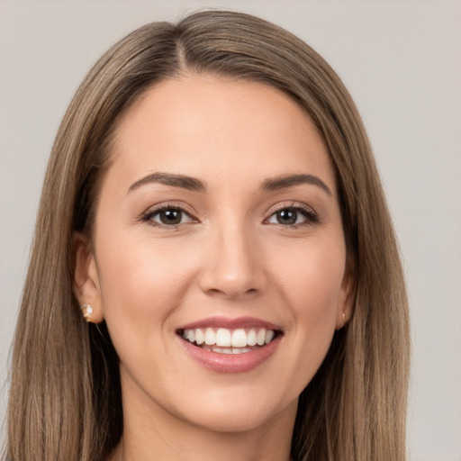 Joyful white young-adult female with long  brown hair and brown eyes