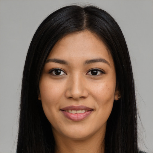 Joyful latino young-adult female with long  brown hair and brown eyes