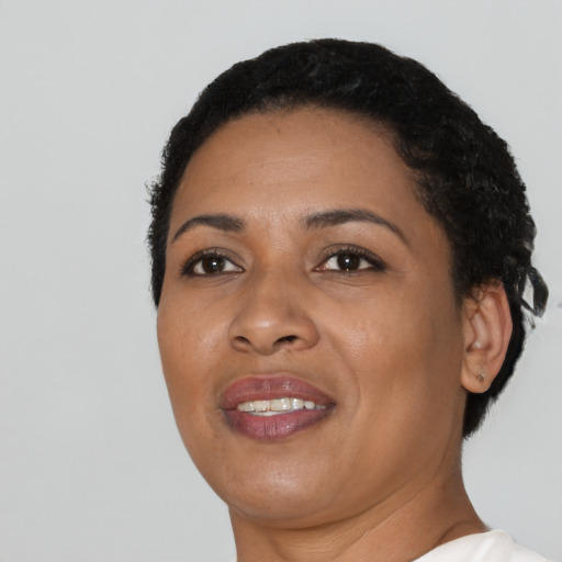 Joyful latino young-adult female with short  black hair and brown eyes