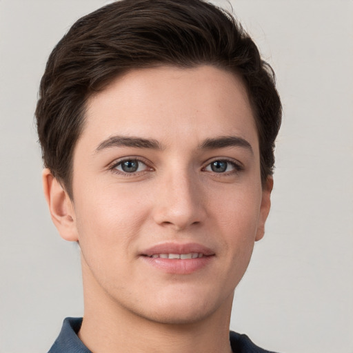 Joyful white young-adult female with short  brown hair and grey eyes