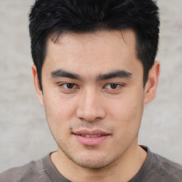 Joyful asian young-adult male with short  black hair and brown eyes