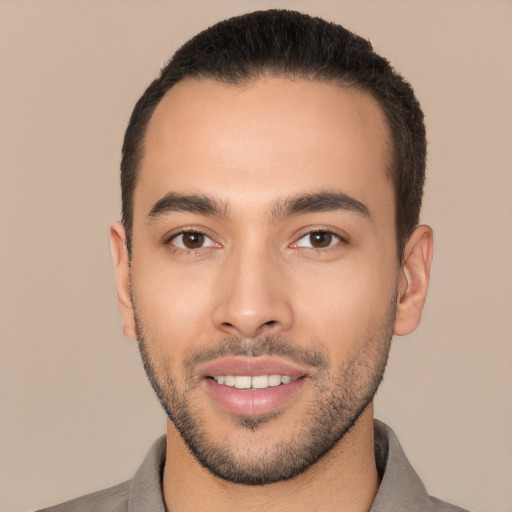 Joyful white young-adult male with short  black hair and brown eyes