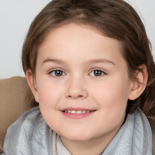 Joyful white child female with medium  brown hair and brown eyes