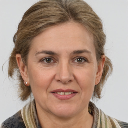 Joyful white adult female with medium  brown hair and grey eyes