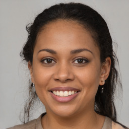 Joyful latino young-adult female with long  brown hair and brown eyes