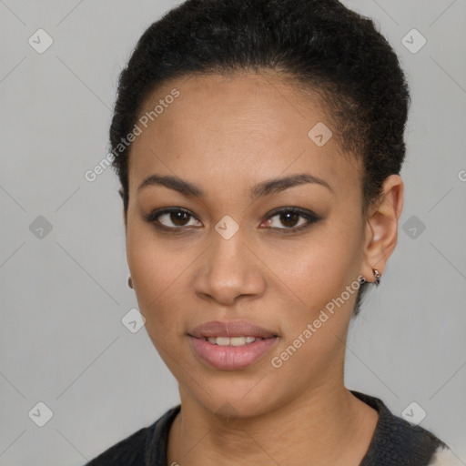 Joyful black young-adult female with short  brown hair and brown eyes