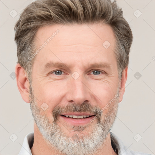 Joyful white adult male with short  brown hair and grey eyes