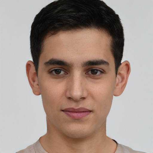 Joyful white young-adult male with short  black hair and brown eyes