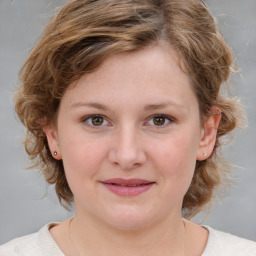 Joyful white child female with medium  brown hair and brown eyes