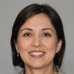 Joyful white adult female with medium  brown hair and brown eyes