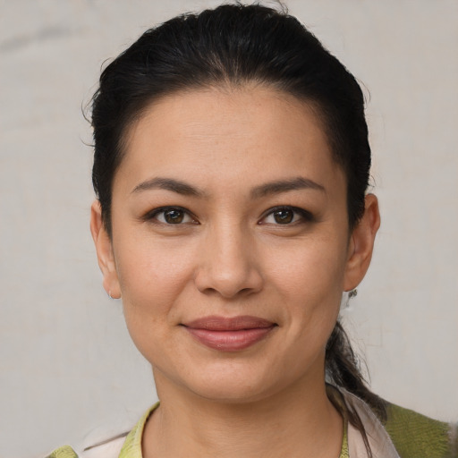 Joyful white young-adult female with short  black hair and brown eyes