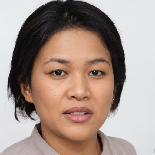 Joyful asian young-adult female with medium  brown hair and brown eyes
