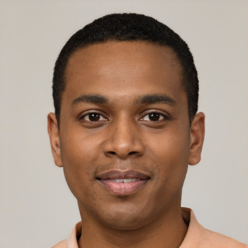 Joyful black young-adult male with short  black hair and brown eyes
