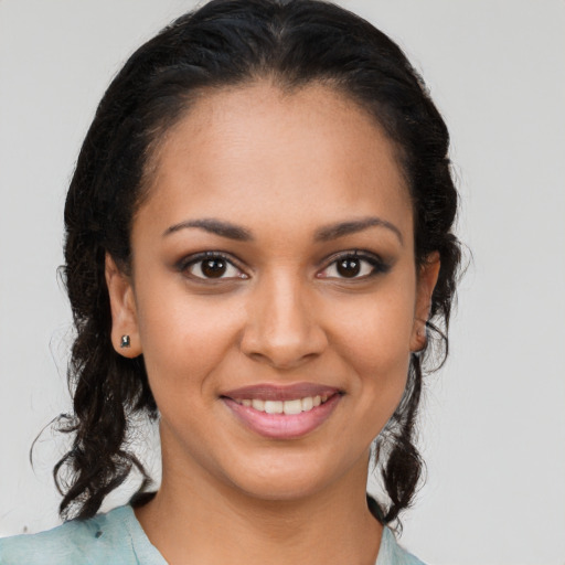 Joyful latino young-adult female with medium  brown hair and brown eyes