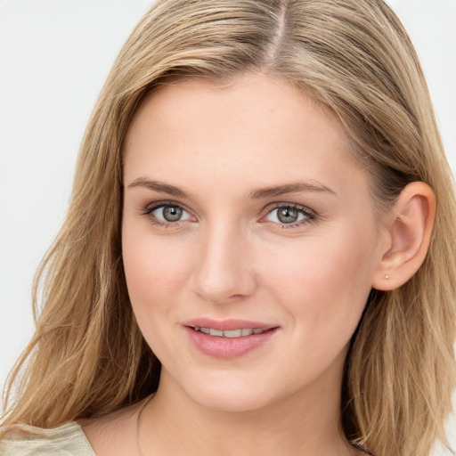 Joyful white young-adult female with long  brown hair and blue eyes