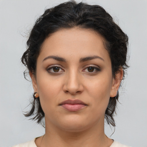 Joyful latino young-adult female with medium  brown hair and brown eyes