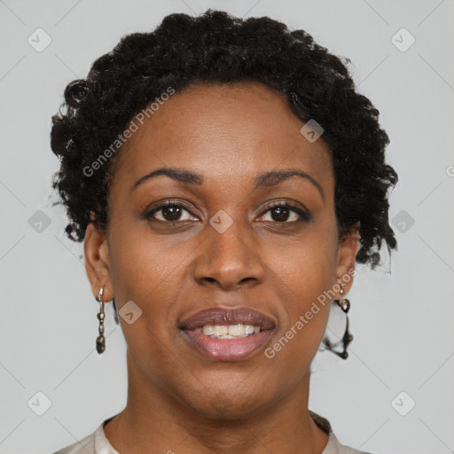 Joyful black adult female with short  brown hair and brown eyes