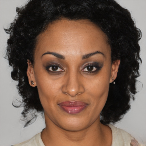Joyful black adult female with short  black hair and brown eyes
