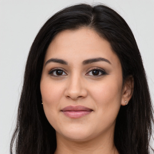 Joyful latino young-adult female with long  black hair and brown eyes