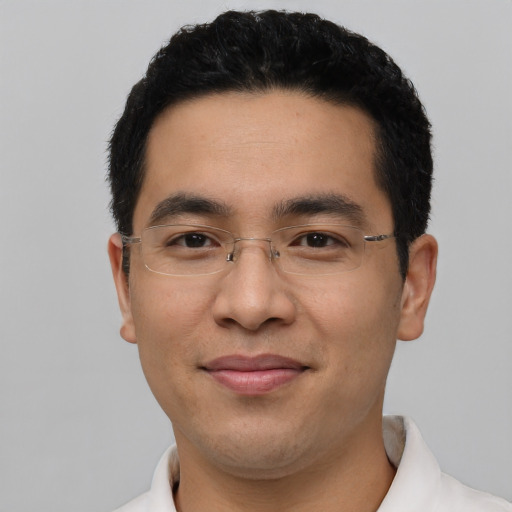 Joyful asian adult male with short  black hair and brown eyes