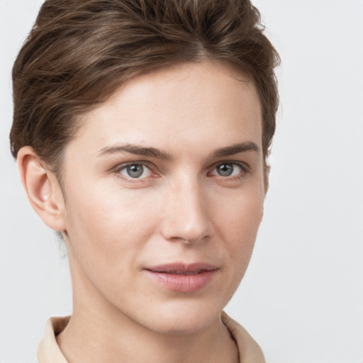 Joyful white young-adult female with short  brown hair and grey eyes