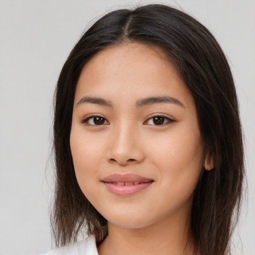 Joyful latino young-adult female with long  brown hair and brown eyes