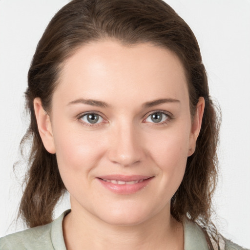 Joyful white young-adult female with medium  brown hair and grey eyes