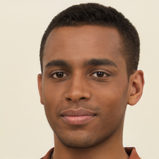 Joyful black young-adult male with short  brown hair and brown eyes