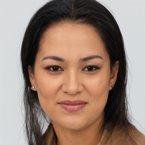 Joyful latino young-adult female with long  brown hair and brown eyes