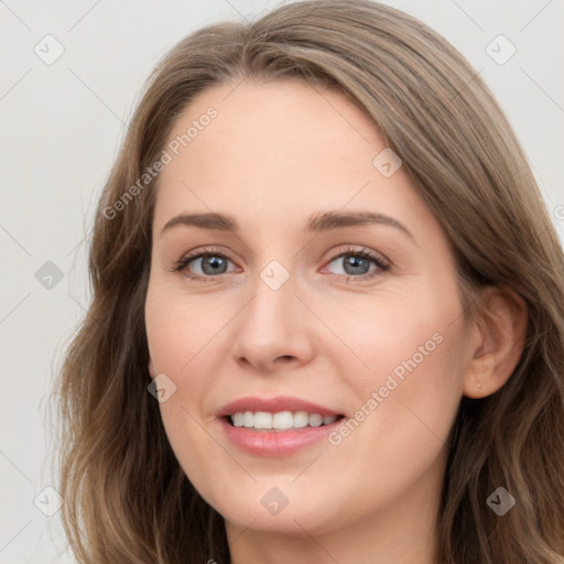 Joyful white young-adult female with long  brown hair and blue eyes