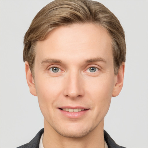 Joyful white young-adult male with short  brown hair and grey eyes