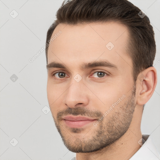 Joyful white young-adult male with short  brown hair and brown eyes