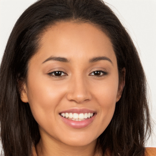 Joyful white young-adult female with long  brown hair and brown eyes