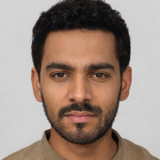 Neutral latino young-adult male with short  black hair and brown eyes