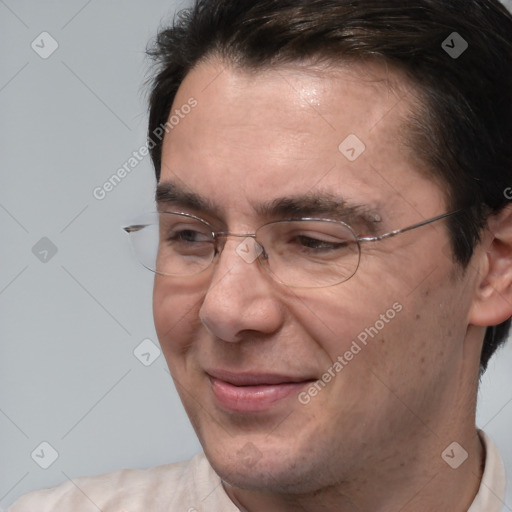 Joyful white adult male with short  brown hair and brown eyes