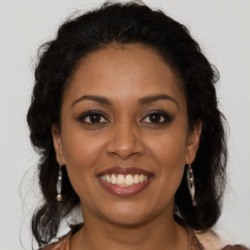 Joyful black young-adult female with medium  brown hair and brown eyes