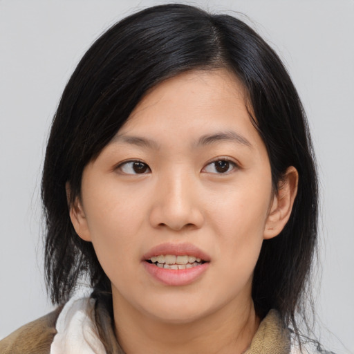 Joyful asian young-adult female with medium  black hair and brown eyes