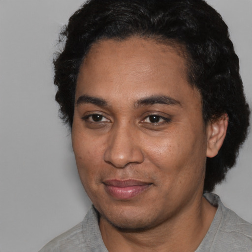 Joyful black adult male with short  black hair and brown eyes