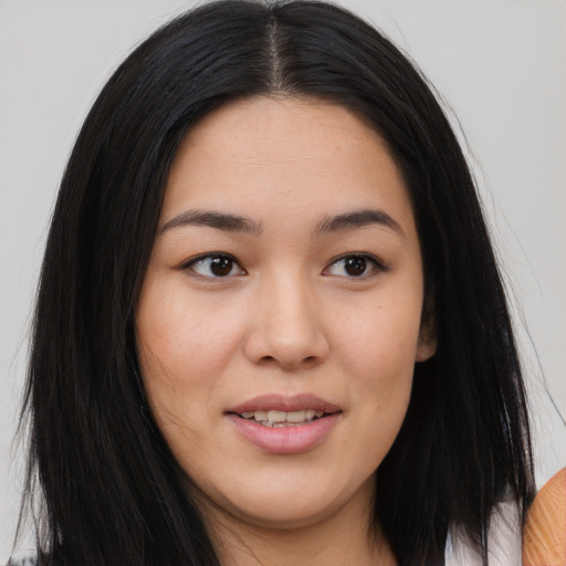 Joyful asian young-adult female with long  black hair and brown eyes