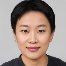 Joyful asian young-adult female with short  black hair and brown eyes