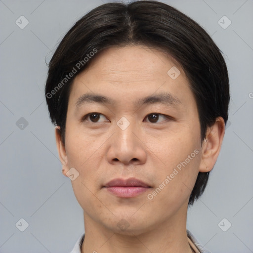 Joyful asian young-adult male with short  brown hair and brown eyes