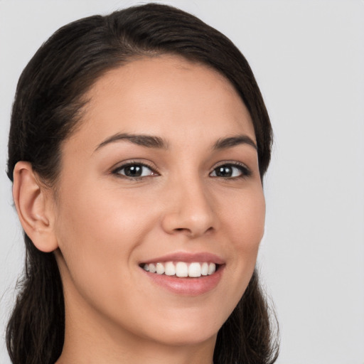 Joyful white young-adult female with long  brown hair and brown eyes